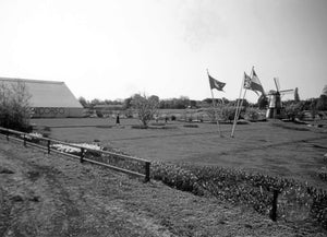 Dutch Farm with Three European Flags on Display and Windmill