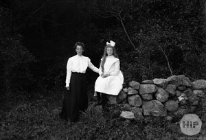  Two Young Women Posing Besides Stone Wall Together Outside Forest, Early 1900s