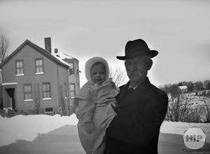 Elderly Elegant Man Posing with Cherubic Young Child on a Snowy Winter Afternoon