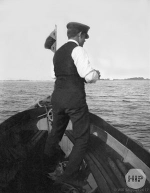 Man standing in boat.