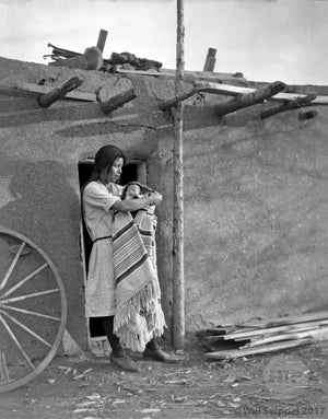 Native American woman with Child  in Adobe Doorway