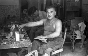A cobbler at work, captured by George Sakata.