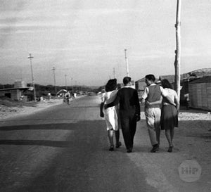 Two couples walking arm in arm in Italy, 1940s