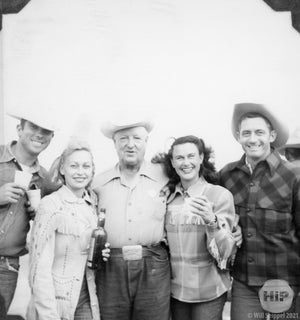 Cowboys and cowgirls celebrate with a drink.