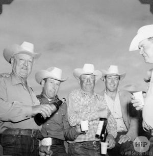 Cowboys enjoy a drink after the show.