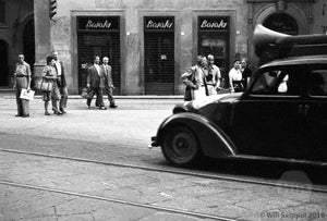 Male and Female Pedestrians Casually Striding Through a Shopping District in Italy, 1940s